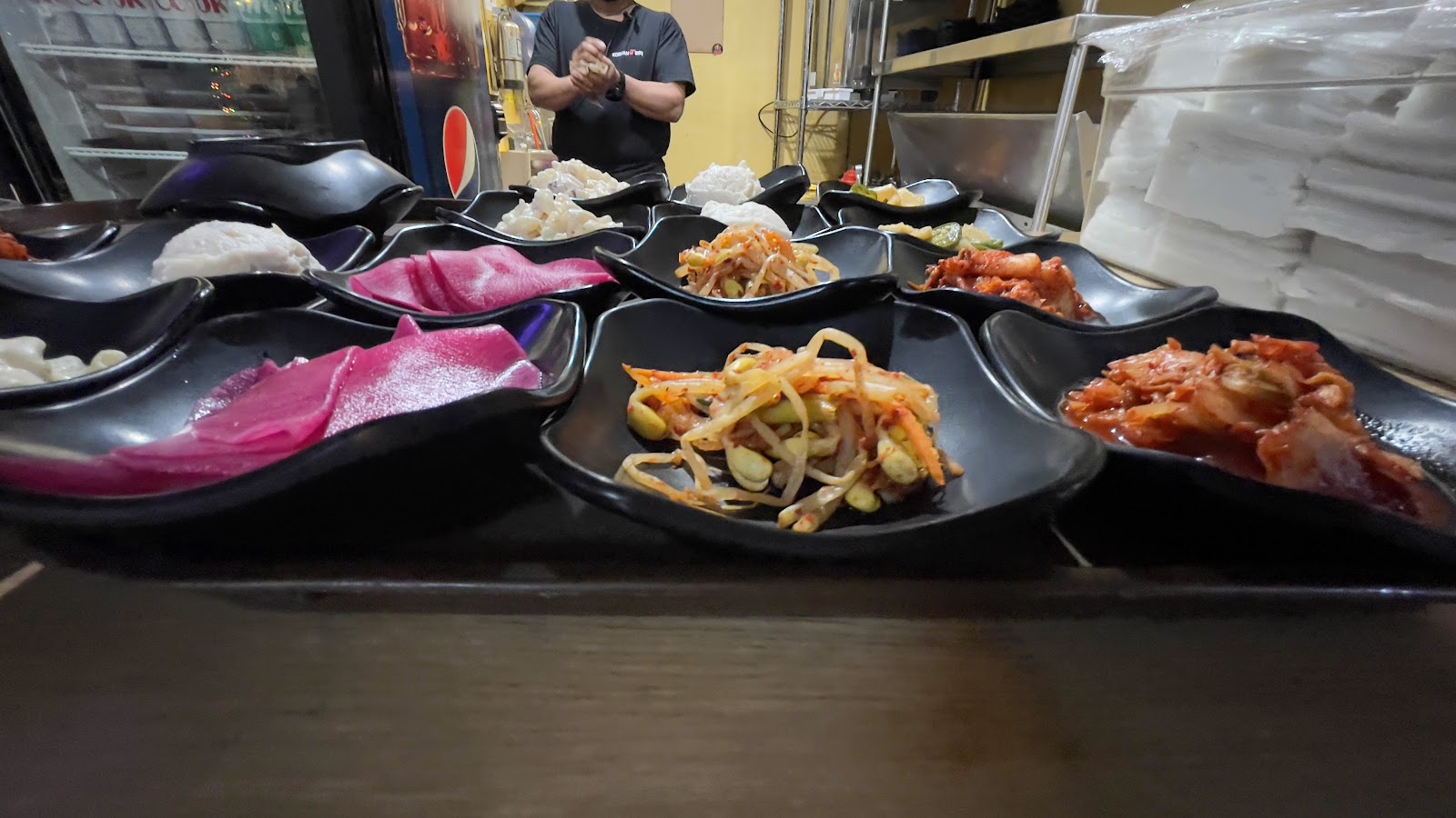 Banchan side dishes lined up for service